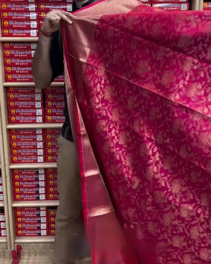 Person holding a large red fabric in front of stacked boxes.